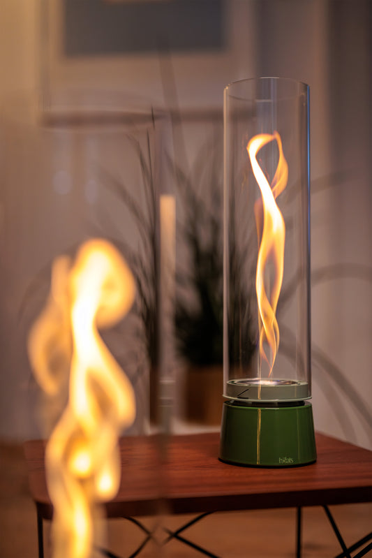 Modern indoor fireplace with swirling flames on a wooden table.